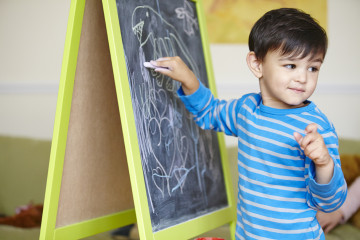 Boy drawing on blackboard