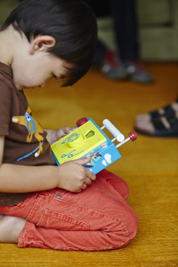 Boy playing with toy radio