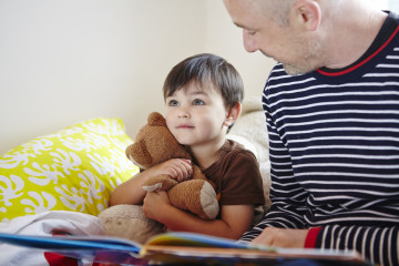 Dad reading to boy