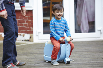 Dad playing with boy on scooter