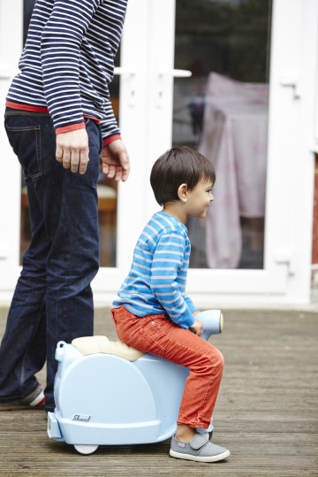 Dad playing with boy on scooter