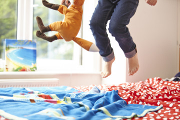 Girl jumping on a bed