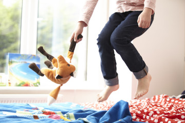 Girl jumping on a bed