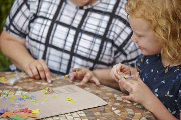 Girl playing with loom bands