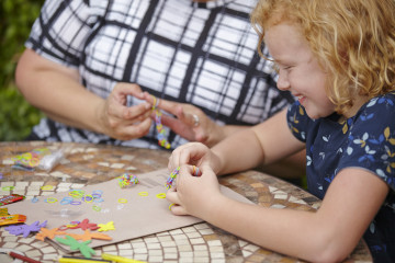 Girl playing with loom bands