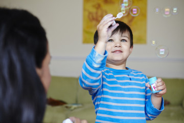 Mum and boy blowing bubbles