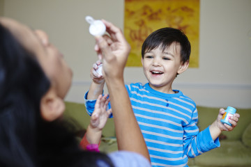 Mum and boy blowing bubbles