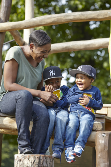 Mum and two boys playing in park