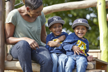 Mum and two boys playing in park