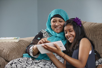 mum and girl looking at a tablet