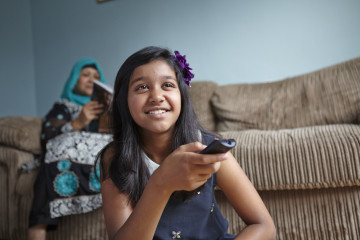 mum and girl watching TV