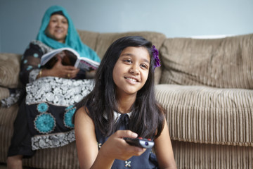 mum and girl watching TV