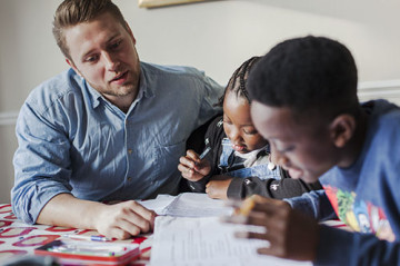 Dad helping son and daughter with homework