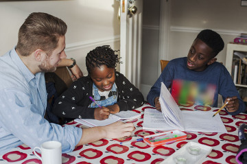 Dad helping son and daughter with homework