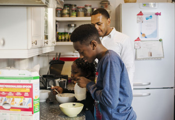 Dad with son and daughter in the kitchen