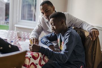 Dad helping son and daughter with homework