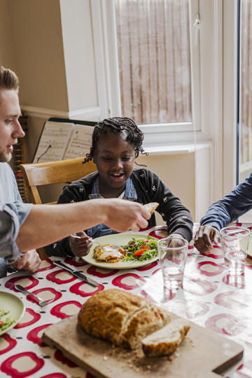 Dad with son and daughter eating at the table