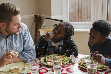 Dad with son and daughter eating at the table