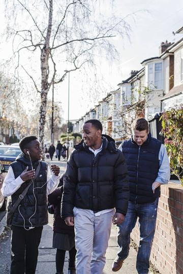 Same sex couple with son and daughter walking to school