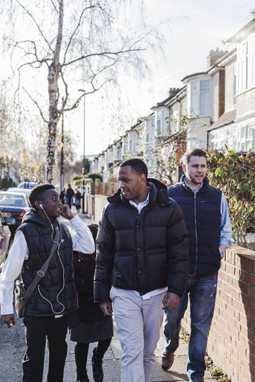 Same sex couple with son and daughter walking to school