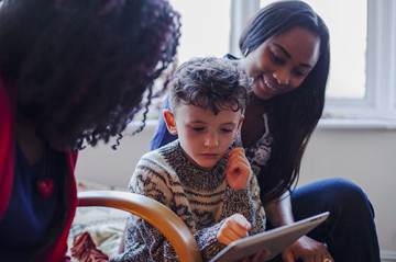 Same sex couple with son reading