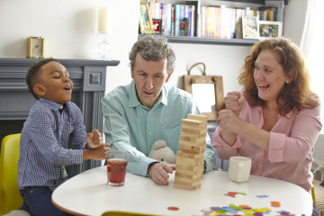 Dad and Mum with son playing game