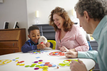 Dad and Mum with son playing game