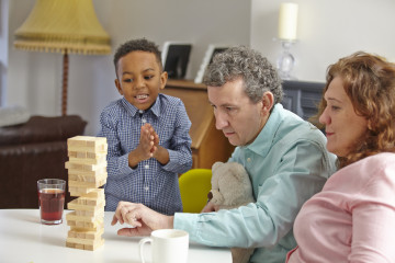 Dad and Mum with son playing game