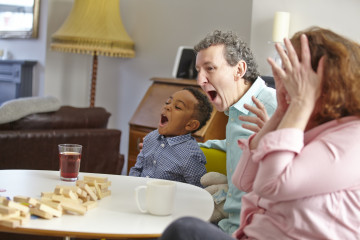 Dad and Mum with son playing game