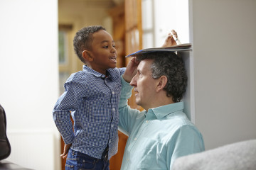 Dad with son measuring height