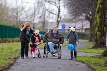 Dad and mum with daughters in park