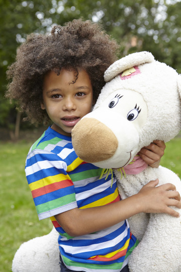 Boy hugs teddy