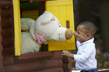 Boy plays with teddy