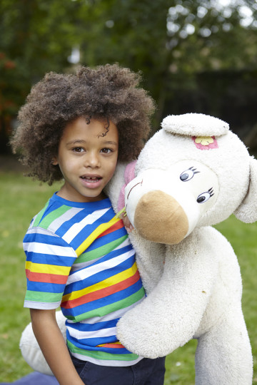 Boy cuddles teddy