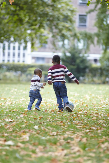 Siblings playing football