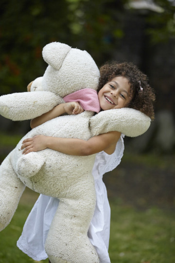 Girl cuddling bear