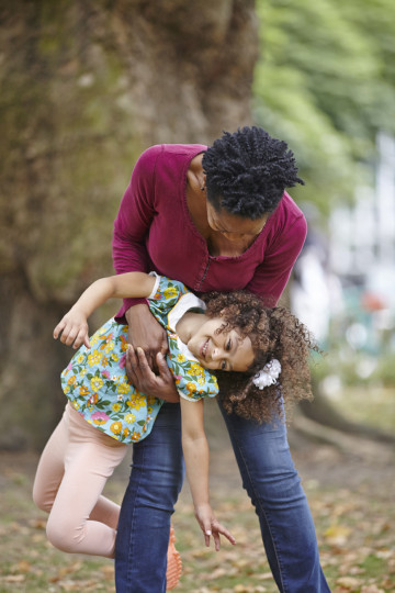 Mum gives daughter a playful lift