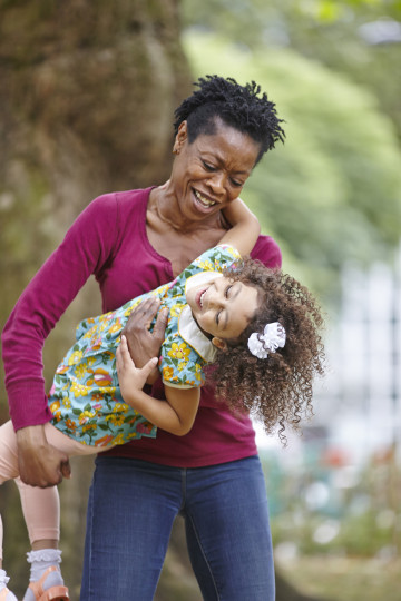 Mum and daughter playful in park