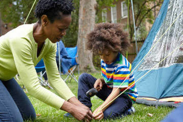 Mum and son pitching tent