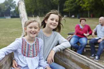 Siblings with mum and dad in background