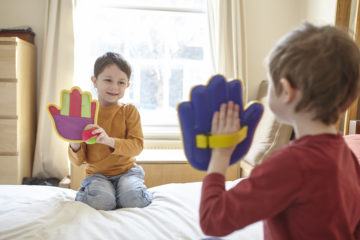 Children playing on bed