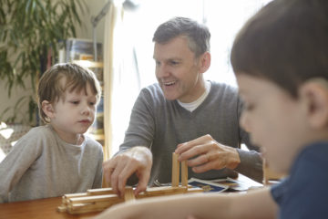 Dad and sons playing