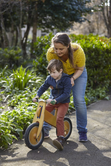 Mum helping son on bike