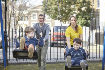 Family playing on swings