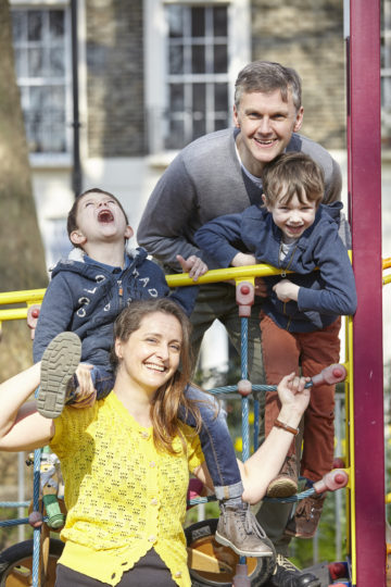 Family laughing in park