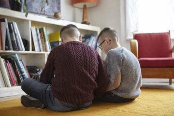 Brothers reading on the rug