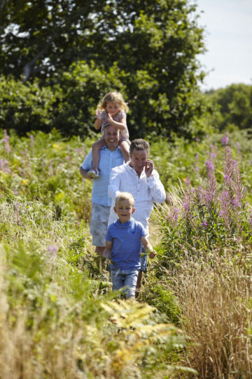 Family walking in field