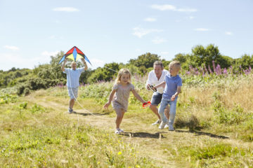 Family playing with kite together