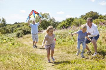 Family plays with kite