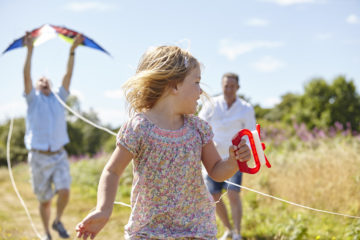 Family playing with kite